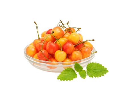 Sweet cherries in a glass bowl isolated on whiteの写真素材