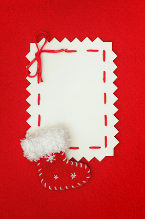 handmade card  empty  blank and Christmas stocking on red の写真素材