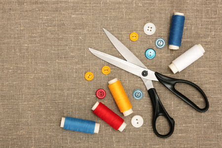 Sewing concept  Scissors, colorful  bobbin thread and buttonsの写真素材