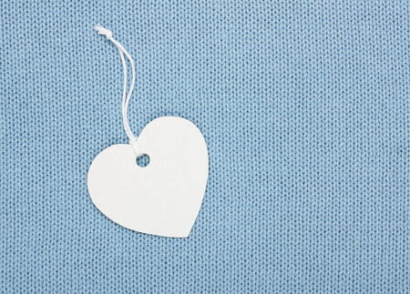 heart shape label tag on  blue knitting backgroundの写真素材