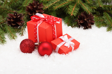 Christmas card: red gift boxes, balls and Christmas tree branch on whiteの写真素材