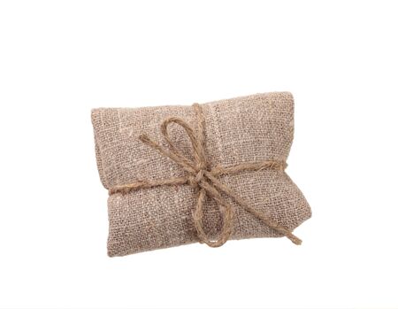 vintage gift wrapped in sacking, isolated on whiteの写真素材