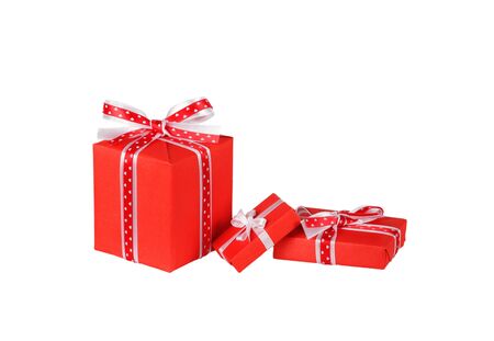 wrapped red gift boxes with ribbon bows isolated on whiteの写真素材