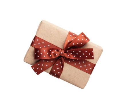 wrapped gift box with ribbon bow isolated on whiteの写真素材