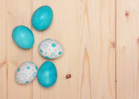 Easter eggs on light-colored wooden background