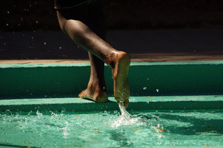 Foot in outdoor swimming pool.