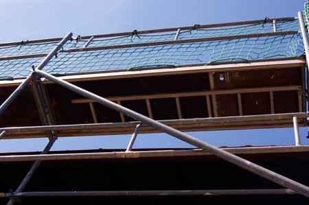 Scaffolding covering a facade of an building under renovation.の写真素材