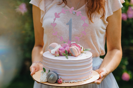 Woman holding birthday cake. Hands of young woman holding birthday cake selective focus.の写真素材