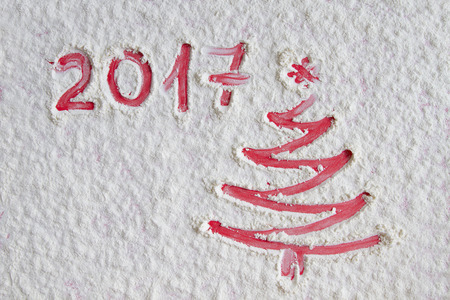 Red Christmas tree on flour background. White flour looks like snow. Top viewの写真素材