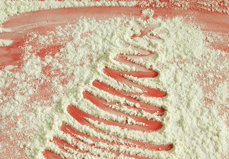 Christmas tree on flour background. White flour looks like snow. Top viewの写真素材