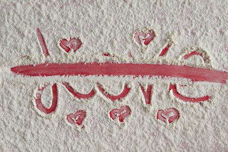 Word love written and crossed out on the flour background の写真素材