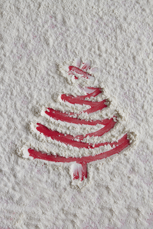 Christmas tree on flour background. White flour looks like snow. Top viewの写真素材