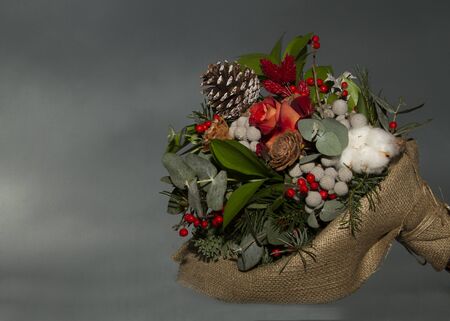 Winter flowers bouquet on dark gray background with place for your textの写真素材