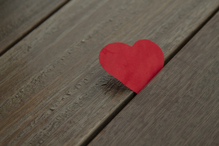 Red paper heart on wood background,  love conceptの写真素材