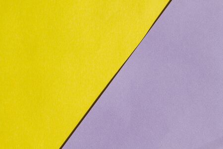 Bright yellow and purple paper texture background diagonal, unusual, modern background, horizontal viewの写真素材