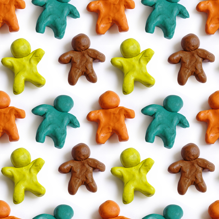 Seamless pattern of colorful plasticine peoples isolated on white background. Rainbow modeling clay texture.の写真素材