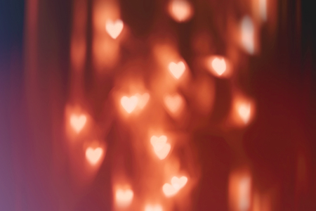 Abstract bokeh background. Holidays blurred light with hearts. Tinted photoの写真素材