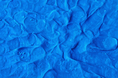 Modeling clay finger textured blue color backdrop. Plasticine handmade backgroundの写真素材
