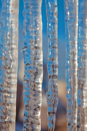 Bright transparent icicles against the background of the blue sky. Winter backdropの写真素材
