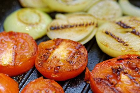 Close up grilled onion and tomatoes. Macro of a vegetable. Shallow depth a fieldの写真素材
