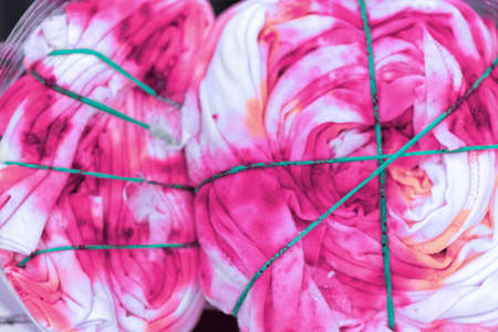 Tie dye technique by folding the clothes of a hand tie dye on cotton fabric.の写真素材