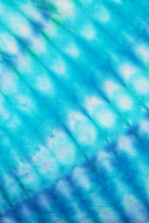 Close up of a colorful tie dye abstract background. Hand dyed on cotton fabric texture backdrop.の写真素材