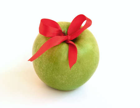 A green apple whith bright red ribbonの写真素材