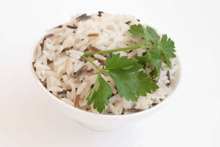 White ceramic bowl with boiled rice isolated on whiteの写真素材