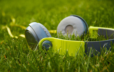 green headphones lying on the grassの写真素材