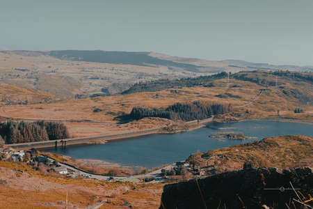 A beautiful shot of a lake in the mountains under the blue skyの写真素材