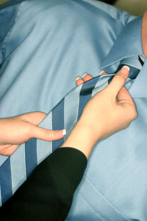 helping with the tieの写真素材