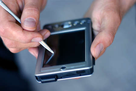 business man working on his palm pilotの写真素材