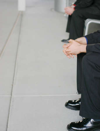 two business men sitting on benchesの写真素材