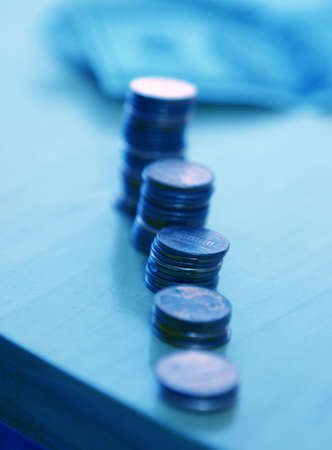 stacks of coins are lined up on the tableの写真素材