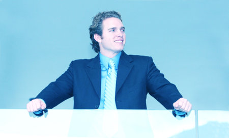 young businessman smile above railing