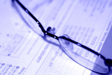 Glasses on top of contract in purple hueの写真素材