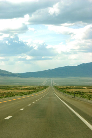 Open road in the middle of the road going through towards the horizon