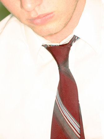 Close-up of the face of a businessman with a white shirt and red tieの写真素材