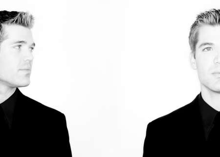 Business man is looking at himself in black and whiteの写真素材