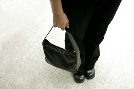 Shot from above of a woman holding a black purseの写真素材