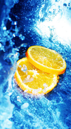 Orange slices in rushing, clear waterの写真素材
