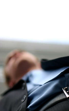 shot from below of blurred business man posing in front of buildingの写真素材