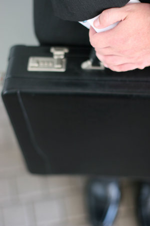 close-up shot of man holding briefcase