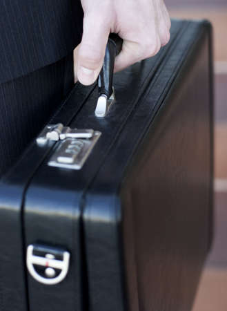 Businessman holding his briefcase in his handの写真素材