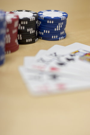 A Hand of Cards lie together on a wooden table