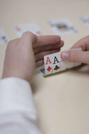Man playing poker at the table with two acesの写真素材
