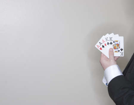 Man showing his hand of poker cards to the cameraのeditorial素材