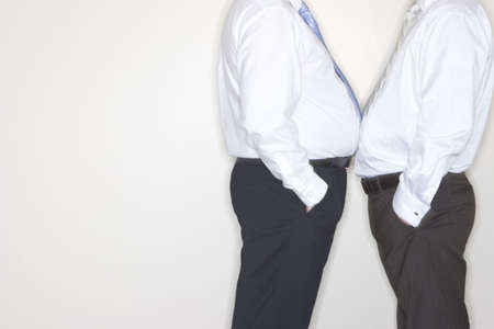 Two businessmen confront each other and face off by standing close to each other in the officeの写真素材