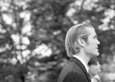 three business men standing and smiling in same directionの写真素材