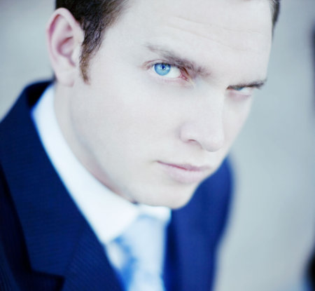 Close up of single white businessman wearing white shirt and blue tie